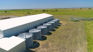Row of round tanks by shed
