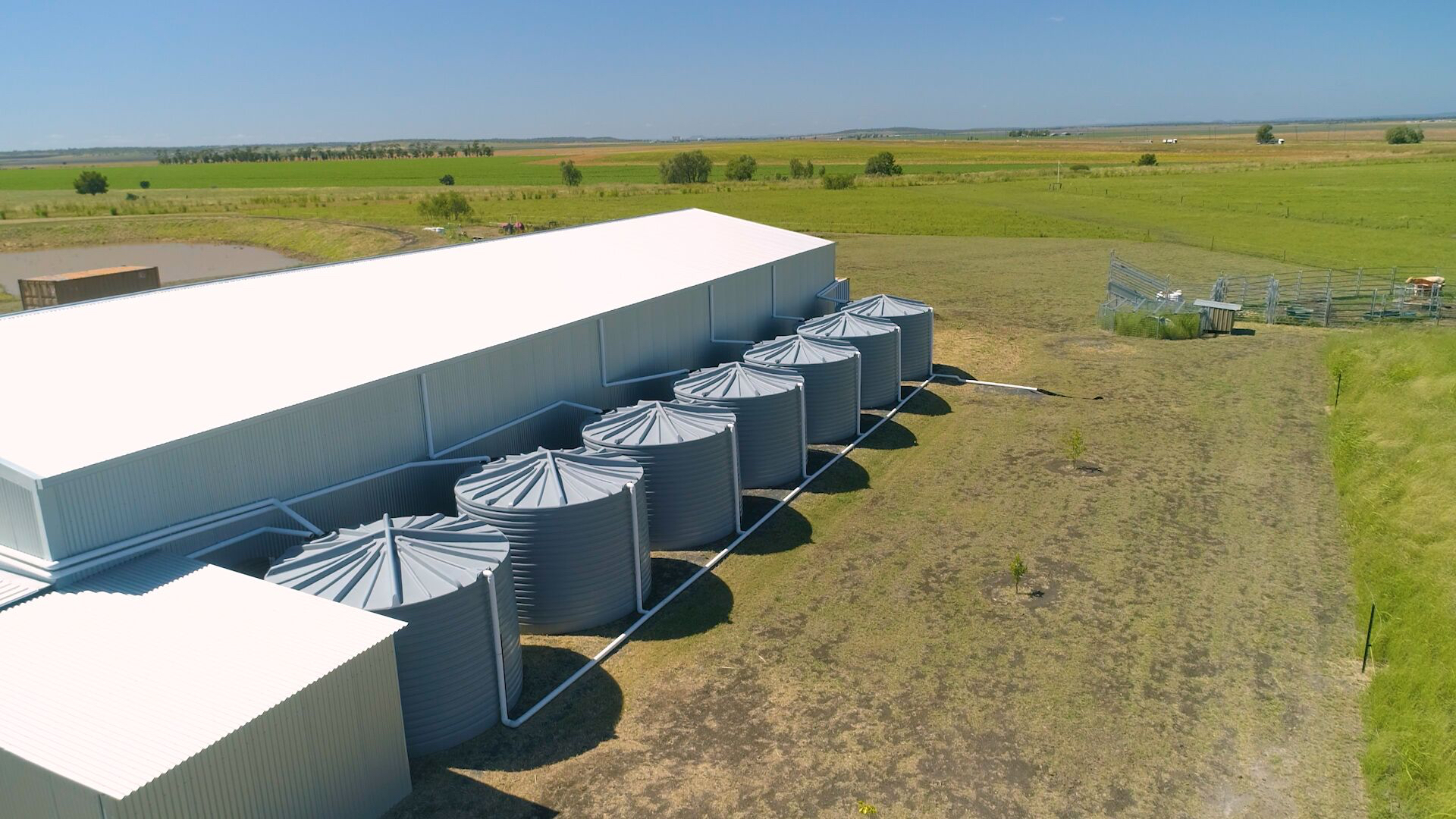 Row of round tanks by shed